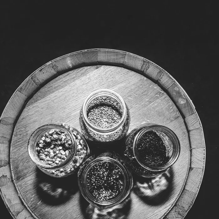 Jars of whiskey grain on a barrel head